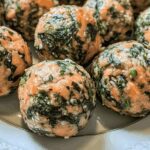 Plate of homemade salmon and spinach balls for dogs, healthy and nutritious dog treats made from fresh ingredients